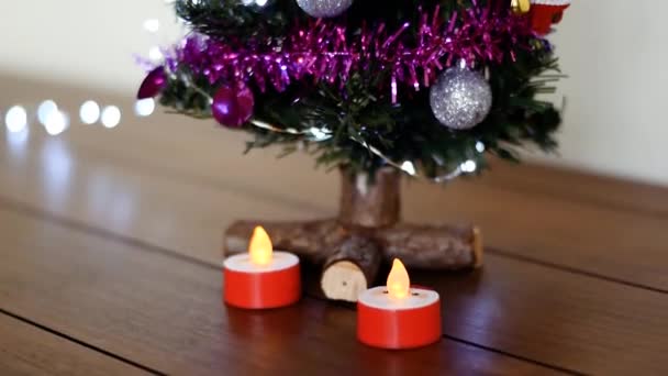 Tilt Shot Christmas Tree Decorations Two Candles — ストック動画