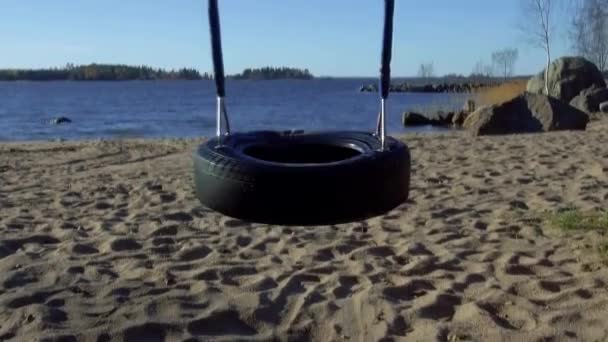 Recycled Car Tire Transformed Playground Swing Beach Slowly Swinging Back — Stock video