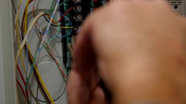 Man Uses Pliers Take Apart Electrical Box — Stockvideo