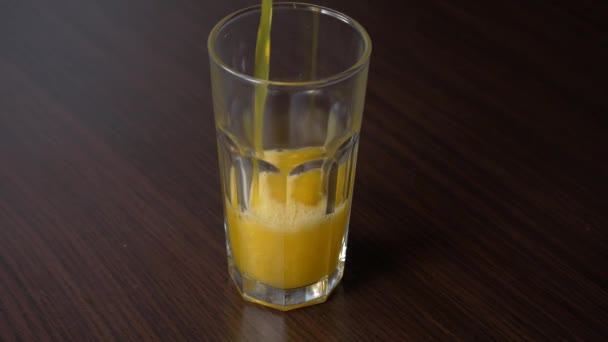 Pouring Sparkling Orange Soda Tall Glass Wooden Table — Vídeo de Stock