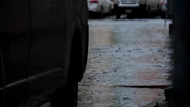 Man Walking Flooded Street Knee High Boots City Submerged Cars — стоковое видео