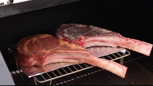 Two Raw Tomahawk Steaks Seasoned Spice Rub Smoker Grill Tilt — Stockvideo