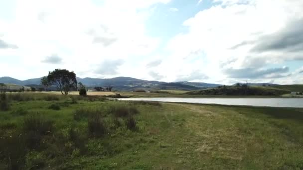 Drone Pan Native Bushes Reveal Water Country Hillside Barn Tasmania — Video