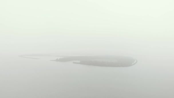 Slow Aerial Approach Mysterious Mist Banks Covered Oval Shaped Island — Video