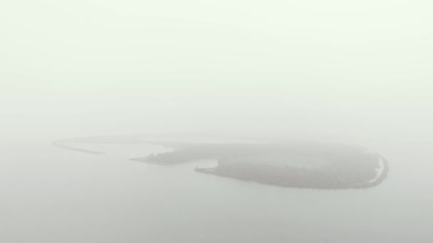 Aerial View Mysterious Mist Banks Covered Oval Shaped Island Backing — Stock Video