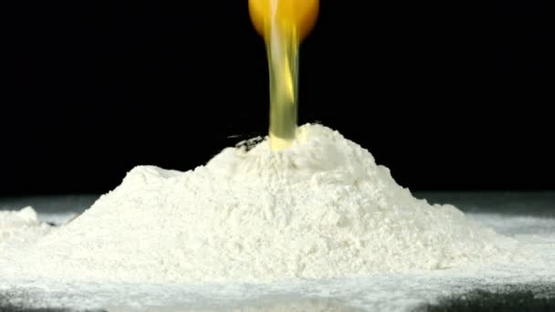 Egg Being Cracked Some Flour Black Background Slow Motion Footage — Wideo stockowe