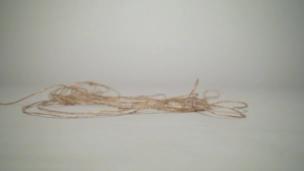 Moving Leaning Skein Natural Grey Background — Stockvideo