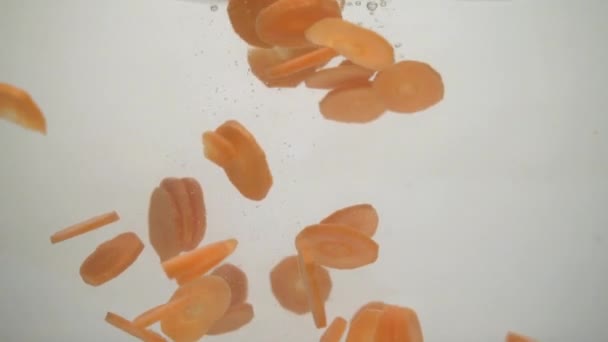 Dropping Crude Carrots Water — Stockvideo