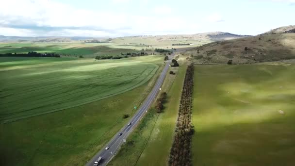 Drone Pan Highway Cars Driving Road Surrounded Green Fields Trees — Stok video