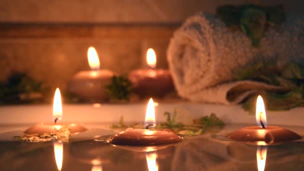 Relaxing Spa Background Candles Floating Bath Water Some Green Petals — Video