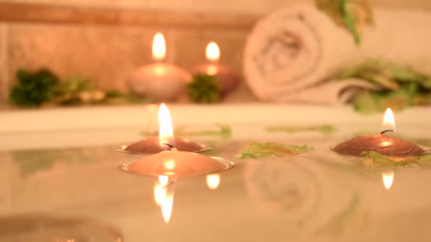 Relaxing Spa Background Candles Floating Bath Water Some Green Petals — Wideo stockowe