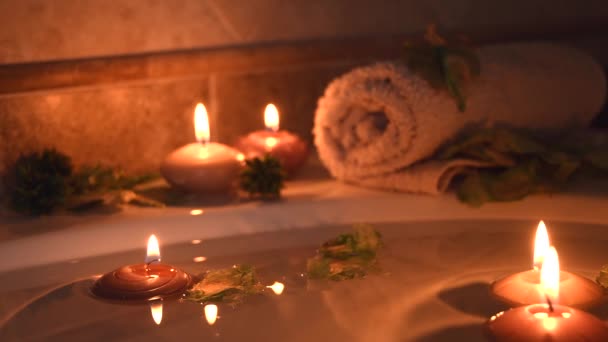 Relaxing Spa Background Candles Floating Bath Water Some Green Petals — Stock video