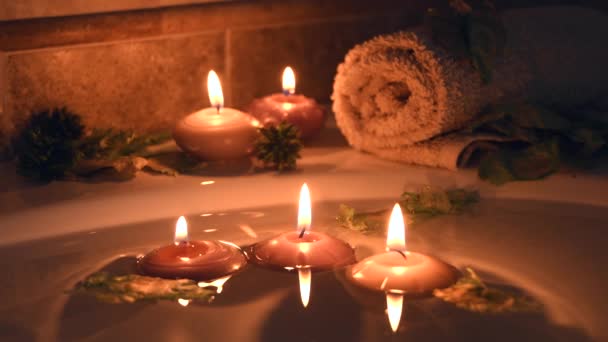 Relaxing Spa Background Candles Floating Bath Water Some Green Petals — ストック動画