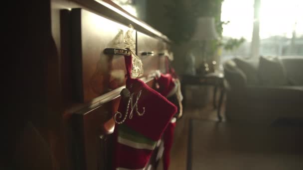 Slow Dolly Christmas Stockings Hanging Dresser Sun Pouring Window Creating — Stock Video