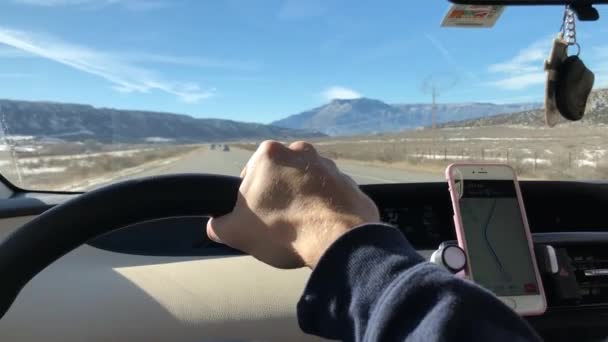 Mans Hand Holding Sterring Wheel Driving Snowy Mountains — Stockvideo