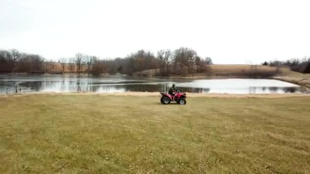 Girl Riding Four Wheeler Green Field Lake — Stockvideo