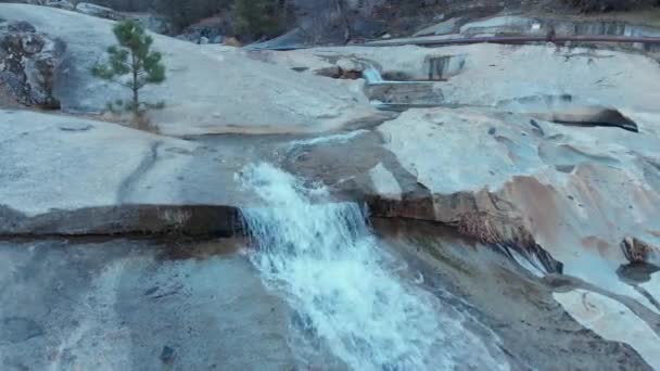 Aerial Dolly Shot Moving Right Cascading Waterfalls Flowing Granite Rock — Vídeos de Stock