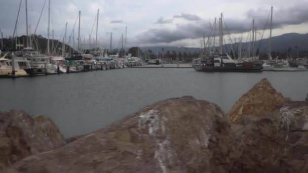 Camera Moving Rocks Showing Anchored Boats Harbor — стоковое видео