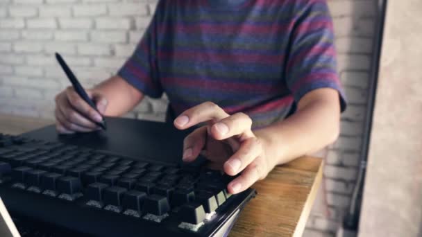 Man Graphic Designer Working Using His Laptop Keyboard Tablet — Stockvideo