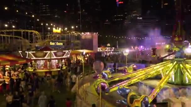 Carnival Many Blinking Carousels Big City — Stockvideo