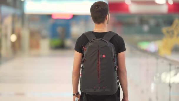 Young Man Black Backpack Walking Mall — Stock Video