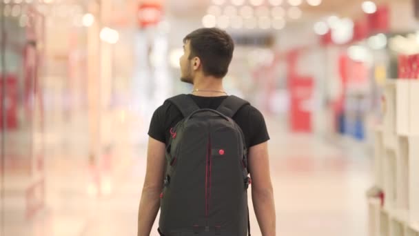 Young Guy Black Backpack Walking Mall Looking Shops — Stock Video