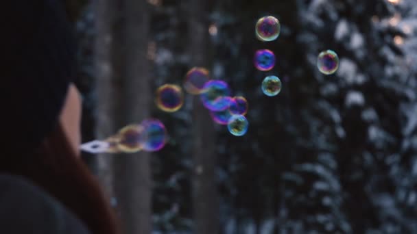 Brunette Woman Winter Clothes Blowing Rainbow Colored Soap Bubbles Flying — Stock video