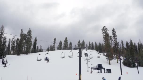 Skiers Ski Lift Storm Approaches Mountain Background — Stock Video