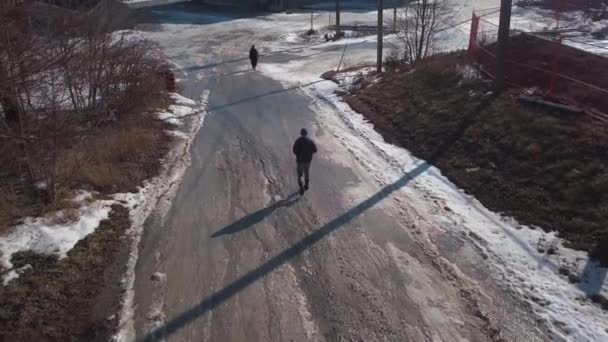 Man Walking Woman Downhill Snowy Road Frozen Dock Winter — Stock Video