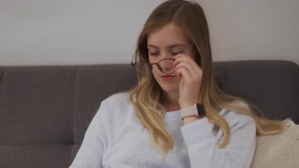 Woman Taking Blue Light Blocking Glasses Cleaning Them Whilst Sat — Stock Video