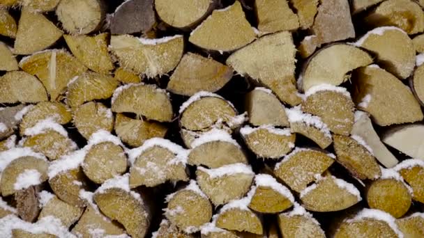 Long Downward Pan Cut Logs Wood Stacked Covered Snow Snowflakes — Vídeo de stock