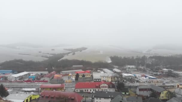 Aerial Forward Snow Covered Hills Industrial Area Train Station Snow — Vídeos de Stock