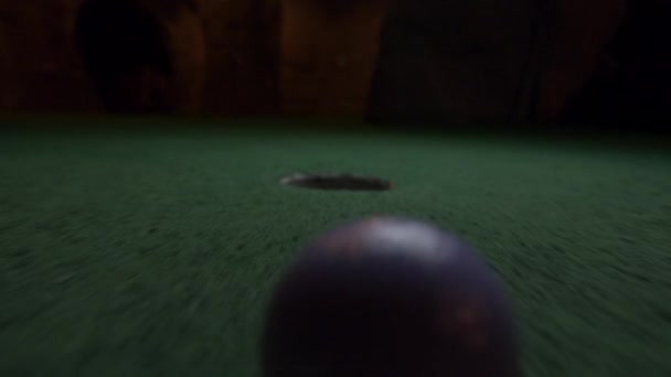Purple Mini Golf Ball Barely Falls Golf Hole Bounces Pocket — Stock Video
