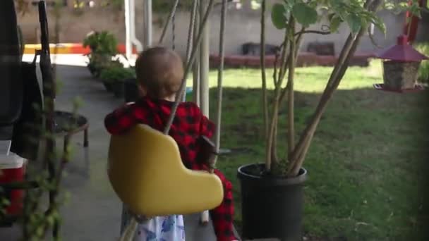 Little Girl Pushing Younger Brother Swing Porch — Stock Video