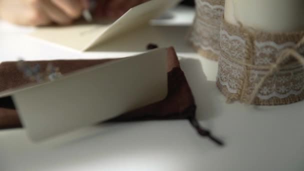 Beautiful Female Hand Writing Wedding Holiday Invitation Bright White Table — Vídeos de Stock