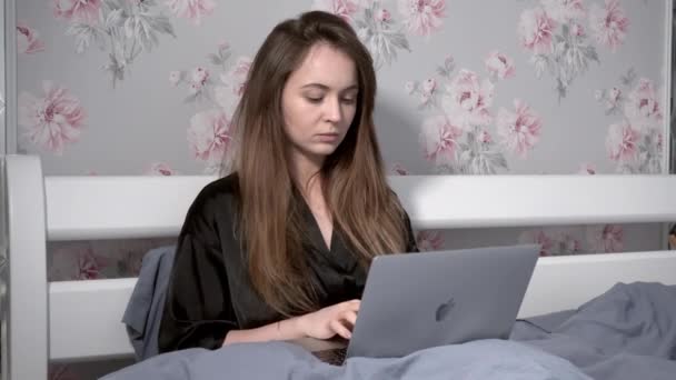 Girl Works Computer Lying Bed — Vídeos de Stock