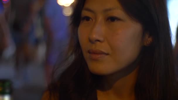 Asian Woman Busy Asian Horeca Street Contemplating Bottle Front Her — Vídeos de Stock
