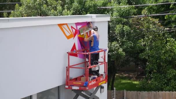 Female Muralist Spray Painting Colorful Graffiti Wall — Vídeos de Stock