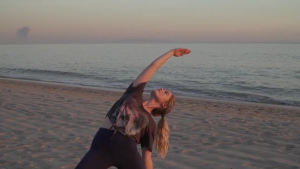 Female Blonde Doing Yoga Pose Beach — стоковое видео