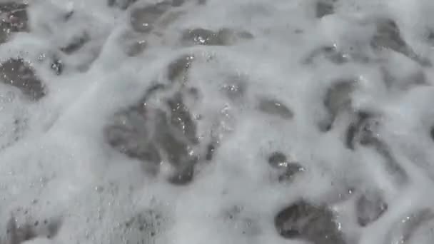 Ocean Wave Crashes Small Black Rocks Water Flows Close — Stockvideo