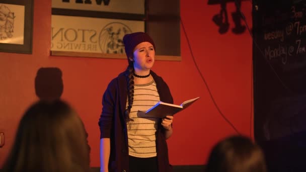 Young Women Reads Slam Poetry Book Stage Wearing Red Jacket — Vídeos de Stock