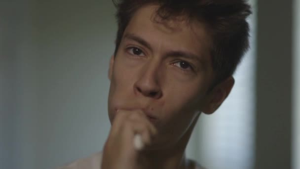 Young Caucasian Man Brushes Teeth Looking Straight Camera — Stock videók