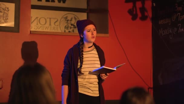 Young Women Reads Slam Poetry Book Walks Stage Wearing Red — Vídeo de Stock