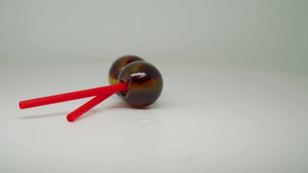 Two Brown Colored Lollipop Crossed Red Stick Close Shot — Vídeos de Stock