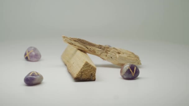 Two Pieces Palo Santo Wood Surrounded Purple Gem Stones Moving — Vídeo de Stock