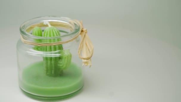 Green Cactus Candle Formed Transparent Jar Yellow Ribbon Close Shot — Αρχείο Βίντεο