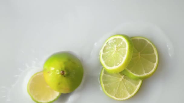 Sliced Citrus Lime Falling White Liquid Filmed Slowmotion — Vídeos de Stock