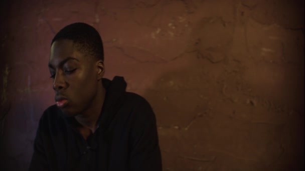 African American Teen Sits Night Intense Look Anamorphic — Stock Video