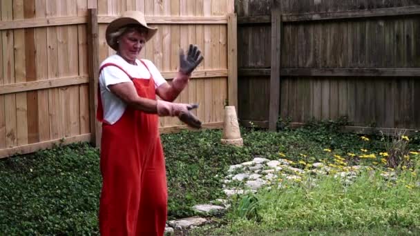 Female Gardener Dusting Hands Gloves Gardening Centerville Ohio Medium Full — стоковое видео