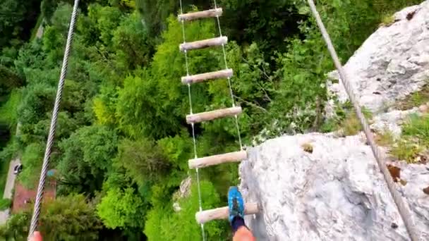 Man Walking Suspension Bridge Made Out Pieces Wood Forest Its — Stock Video